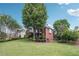 Spacious front yard of this brick home with mature trees and manicured landscaping at 6640 Stratford Pl, Cumming, GA 30040