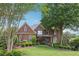 Beautiful red brick home with mature landscaping and a well-manicured lawn at 6640 Stratford Pl, Cumming, GA 30040