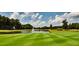 Scenic golf course view with a tranquil pond and fountain feature at 6640 Stratford Pl, Cumming, GA 30040