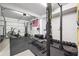 Home gym equipped with free weights, squat rack and cardio machines, offering a convenient fitness space at 6640 Stratford Pl, Cumming, GA 30040