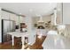 Well-lit kitchen with white cabinets, stone backsplash, stainless steel appliances, and island at 6640 Stratford Pl, Cumming, GA 30040