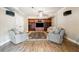 Inviting living room with hardwood floors, custom shelving, and comfortable seating, perfect for relaxation at 6640 Stratford Pl, Cumming, GA 30040