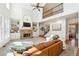 Inviting living room with stone fireplace, built-in shelving, and high ceilings at 6640 Stratford Pl, Cumming, GA 30040