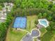 Aerial view of community tennis courts and pool area with lush surrounding greenery at 912 Santa Anita Dr, Woodstock, GA 30189