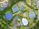 Aerial view of community tennis and basketball courts, pool, clubhouse, and neatly landscaped grounds at 912 Santa Anita Dr, Woodstock, GA 30189