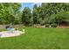 Well-maintained backyard with a large green lawn and beautiful landscaping offers space for relaxation and play at 912 Santa Anita Dr, Woodstock, GA 30189