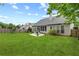 Spacious backyard with well-manicured lawn and an enclosed back porch is perfect for enjoying the outdoors at 912 Santa Anita Dr, Woodstock, GA 30189
