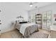 Bright bedroom with a decorative bed, large windows, and a ceiling fan at 912 Santa Anita Dr, Woodstock, GA 30189