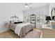 Bright bedroom with a decorative bed, large windows, and a ceiling fan at 912 Santa Anita Dr, Woodstock, GA 30189