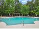 Beautiful community pool featuring a pergola, umbrellas, and ample seating for relaxation at 912 Santa Anita Dr, Woodstock, GA 30189