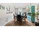 Elegant dining room with stylish furniture, wainscoting and modern chandelier lighting at 912 Santa Anita Dr, Woodstock, GA 30189