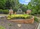 Community entrance sign featuring brick accents, manicured landscaping, and Brookshire lettering at 912 Santa Anita Dr, Woodstock, GA 30189