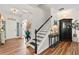 Welcoming foyer with hardwood floors, staircase, and decorative furnishings at 912 Santa Anita Dr, Woodstock, GA 30189