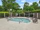 Relaxing hot tub area with chairs, surrounded by lush landscaping and a decorative black metal fence at 912 Santa Anita Dr, Woodstock, GA 30189