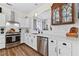 Bright kitchen with white cabinets, tile backsplash, stainless steel appliances, and hardwood floors at 912 Santa Anita Dr, Woodstock, GA 30189
