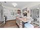 Open concept kitchen featuring a butcher block island with white wicker chairs and stainless appliances at 912 Santa Anita Dr, Woodstock, GA 30189