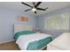 Bright bedroom featuring a ceiling fan, window with blinds, and neutral wall color at 3102 Balearic Se Dr, Marietta, GA 30067