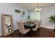 Dining room with hardwood floors, a large table with seating for six, and a window with blinds at 3102 Balearic Se Dr, Marietta, GA 30067