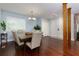 Dining room with hardwood floors, a table with seating for six, and a view into the foyer at 3102 Balearic Se Dr, Marietta, GA 30067