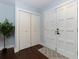 A brightly lit foyer area with hardwood floors, white closets, and a white front door at 3102 Balearic Se Dr, Marietta, GA 30067
