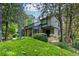 Two story home featuring a charming design and lush landscaping with mature trees and manicured bushes at 3102 Balearic Se Dr, Marietta, GA 30067