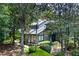 Two story home featuring a charming design and lush landscaping with mature trees and manicured bushes at 3102 Balearic Se Dr, Marietta, GA 30067