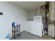 Laundry room with washer, dryer, storage shelf, and utility connections at 3102 Balearic Se Dr, Marietta, GA 30067