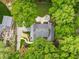 Stunning aerial view of a home with a landscaped yard, patio, and lush green trees providing privacy at 4643 River Ct, Peachtree Corners, GA 30097