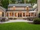 A cozy backyard patio with seating and lush green lawn is visible through arched windows and doors at 4643 River Ct, Peachtree Corners, GA 30097