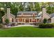 An expansive backyard featuring a patio with ample seating and a lush lawn perfect for outdoor entertaining at 4643 River Ct, Peachtree Corners, GA 30097