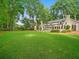 Spacious backyard with lush green lawn and mature trees create a private and serene outdoor space at 4643 River Ct, Peachtree Corners, GA 30097