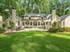 Expansive backyard features a patio with ample seating and a well-manicured lawn perfect for outdoor entertaining at 4643 River Ct, Peachtree Corners, GA 30097