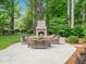 Cozy backyard patio with an outdoor fireplace and comfortable seating, ideal for entertaining or relaxing at 4643 River Ct, Peachtree Corners, GA 30097