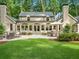 Lush backyard features a patio with dining set and an outdoor grill, perfect for relaxation and enjoying outdoor meals at 4643 River Ct, Peachtree Corners, GA 30097