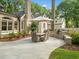 Beautiful backyard patio with dining table, umbrella, and grill; perfect for outdoor gatherings and summer meals at 4643 River Ct, Peachtree Corners, GA 30097