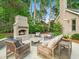 A charming backyard featuring an outdoor fireplace and comfortable seating area for outdoor gatherings at 4643 River Ct, Peachtree Corners, GA 30097
