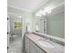 Bathroom vanity with granite countertop and large mirror, and view into the toilet room at 4643 River Ct, Peachtree Corners, GA 30097
