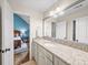 Bathroom featuring granite countertops, under-cabinet storage and a large mirror in neutral decor at 4643 River Ct, Peachtree Corners, GA 30097