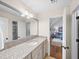 Bathroom vanity with granite countertop and view into the living area beyond at 4643 River Ct, Peachtree Corners, GA 30097