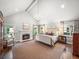 A stunning bedroom with vaulted ceiling, fireplace, and view into the backyard at 4643 River Ct, Peachtree Corners, GA 30097