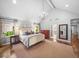 Spacious main bedroom featuring a vaulted ceiling, fireplace view, and hardwood flooring at 4643 River Ct, Peachtree Corners, GA 30097