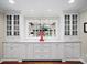 Butler's pantry featuring white cabinets, glass displays, and a marble countertop at 4643 River Ct, Peachtree Corners, GA 30097