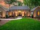 Inviting brick home with landscape lighting, manicured lawn and charming front entry at 4643 River Ct, Peachtree Corners, GA 30097