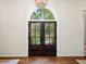 Interior view of double front doors with palladian window revealing landscaped exterior at 4643 River Ct, Peachtree Corners, GA 30097