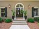 Elegant entryway featuring a double door, exterior lanterns and manicured shrubbery at 4643 River Ct, Peachtree Corners, GA 30097