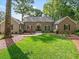 Charming single-story brick home with a well-manicured lawn and inviting walkway at 4643 River Ct, Peachtree Corners, GA 30097