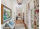 Long hallway with hardwood floors, decorative lighting, and art-adorned walls at 4643 River Ct, Peachtree Corners, GA 30097