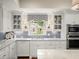 Bright kitchen with white cabinets, granite countertops and stainless appliances at 4643 River Ct, Peachtree Corners, GA 30097