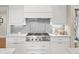 Modern kitchen with stainless steel gas range, subway tile backsplash, and white cabinets at 4643 River Ct, Peachtree Corners, GA 30097