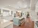 Open kitchen with large island, wood floors, pendant lights, and modern appliances at 4643 River Ct, Peachtree Corners, GA 30097